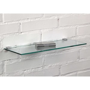 Mensola in vetro t.b.t. con supporti argentati su muro di mattoni bianchi.