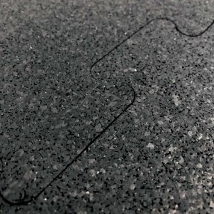 Primo piano di un rivestimento murale t.b.t. scuro con texture screziata.