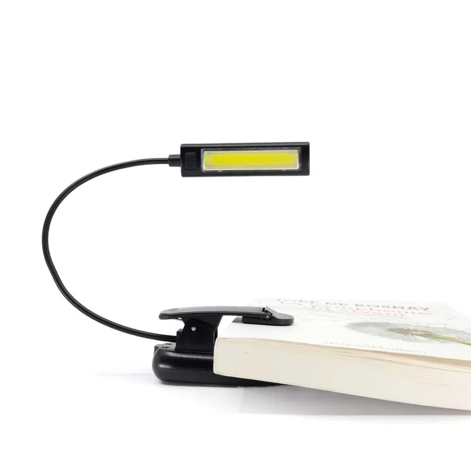 Lampada da lettura t.b.t. nera con clip fissata al libro.