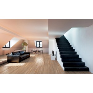 Soggiorno luminoso con piastrelle per pavimenti effetto legno e scala nera.