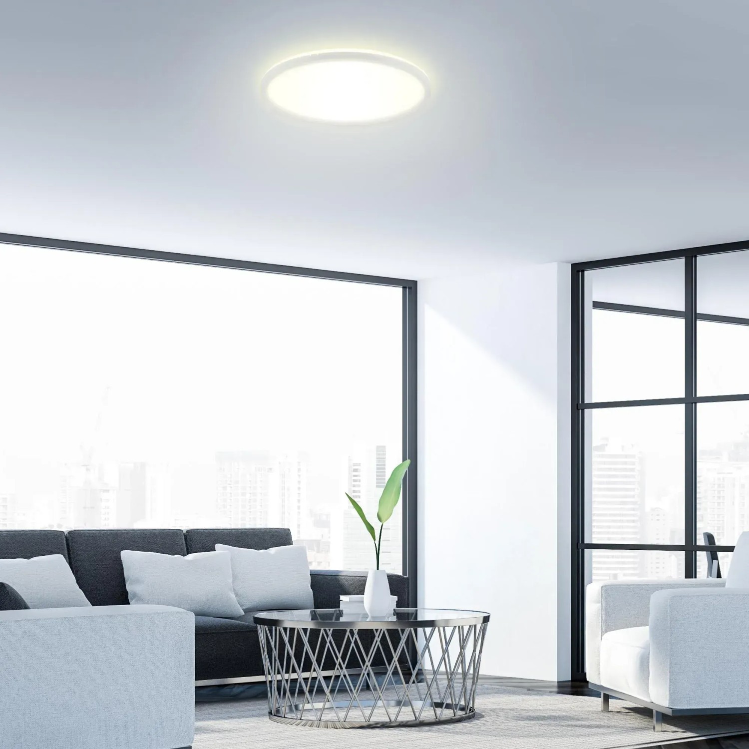 Plafoniera LED Brilo Slim 22W rotonda bianca illuminata, montata su un soffitto del soggiorno.
