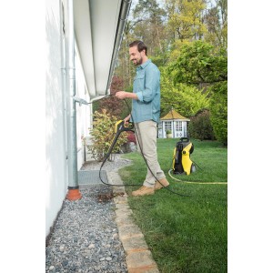 Uomo pulisce la grondaia con idropulitrice Kärcher e tubo di pulizia tubi da 7,5 m.