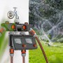 Centralina per irrigazione Gardena con tubi collegati in giardino.