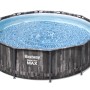 Piscina rotonda t.b.t. con struttura in acciaio e effetto legno per il giardino.
