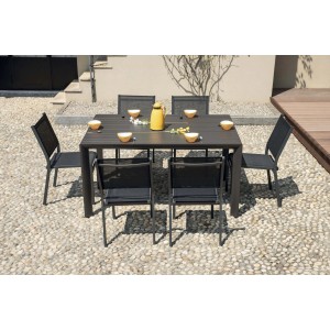Set tavolo da giardino con 6 sedie su ghiaia. Tavolo e sedie in grigio scuro.