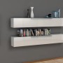 Due mensole a muro bianche e lucide come Tasselli per riporre libri e decorazioni.