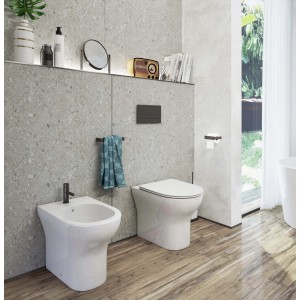 Bidet t.b.t. bianco in bagno moderno con WC e pavimento in legno.
