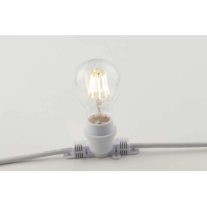 Dettaglio di una lampada a portale t.b.t. con lampadina trasparente e cavo bianco.