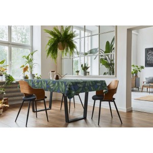 Tavolo da pranzo con tovaglia t.b.t. blu scuro con motivo a foglie verdi.