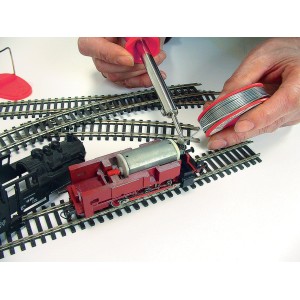 Set per saldatura Rothenberger durante la saldatura di un modellino ferroviario. Saldatore, stagno e binari nell'immagine.