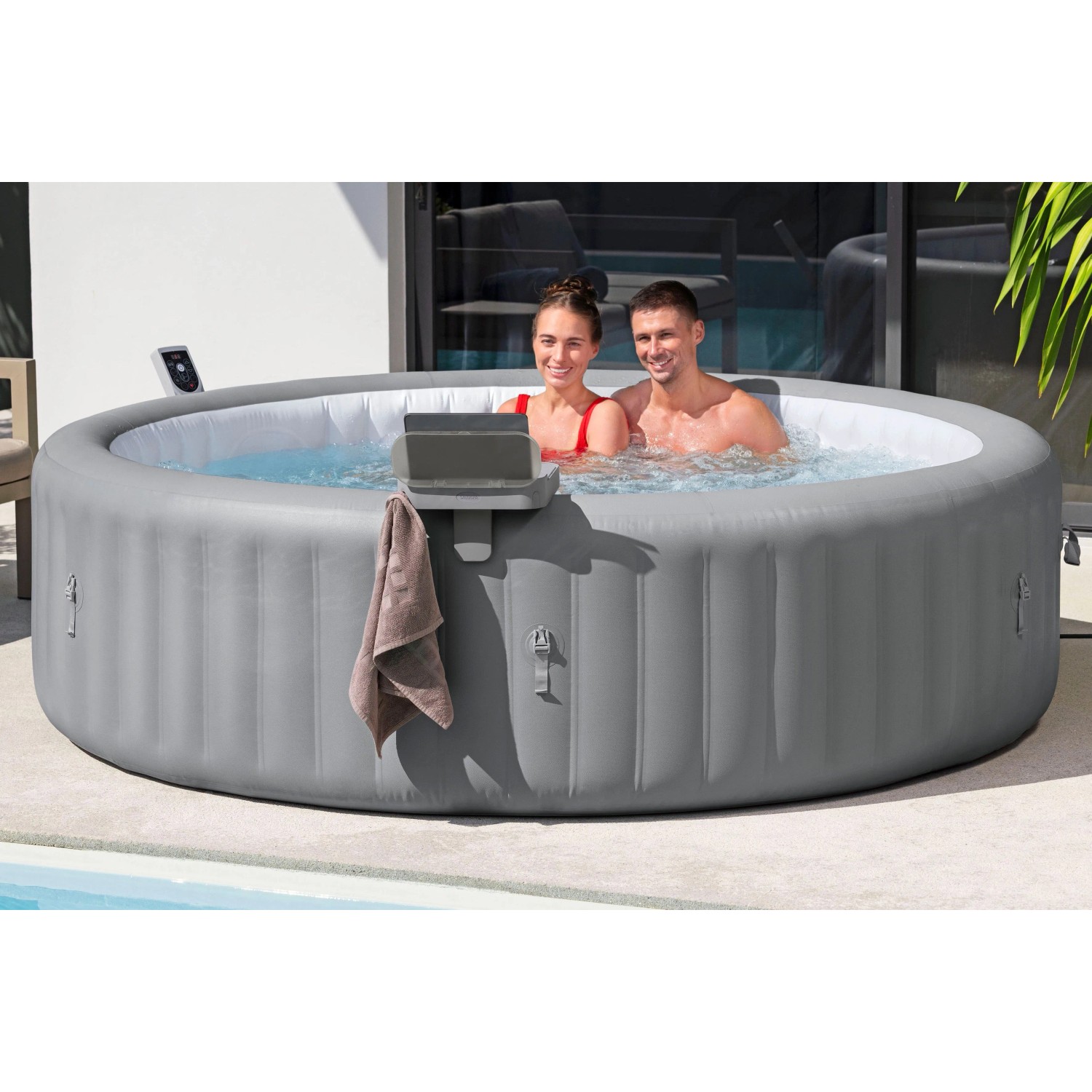 Bestway LAY-Z-SPA con vassoio 4-in-1, asciugamano e persone in acqua.