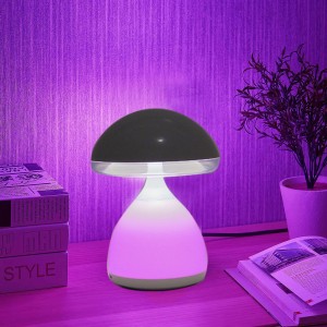 Lampada da lettura t.b.t. a forma di fungo con paralume nero e luce colorata.