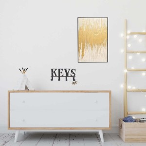 Bacheca decorativa t.b.t. con motivo astratto dorato in cornice.