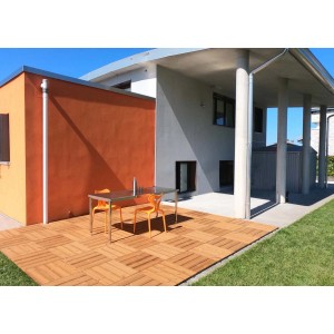 Posa di piastrelle per pavimentazione esterna t.b.t. in legno con area salotto davanti a casa moderna.