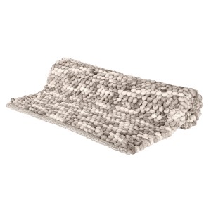 Tappeto da bagno t.b.t. grigio arrotolato con texture a pallini.