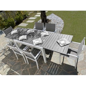 Tavolo da giardino grigio t.b.t. con sedie e stoviglie su un patio.