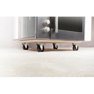 Tavola di trasporto rettangolare TE-200 B con ruote sotto un forno su moquette.