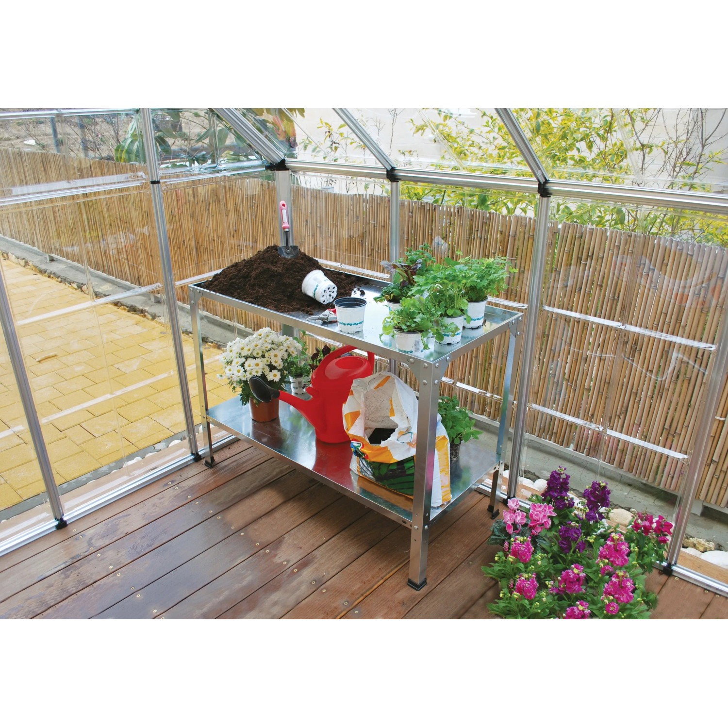 Scaffale Palram in metallo per serra con piante e accessori da giardinaggio.
