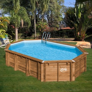 Piscina ovale in legno Gre Safran 2 (620x395x136 cm) con scaletta in giardino.