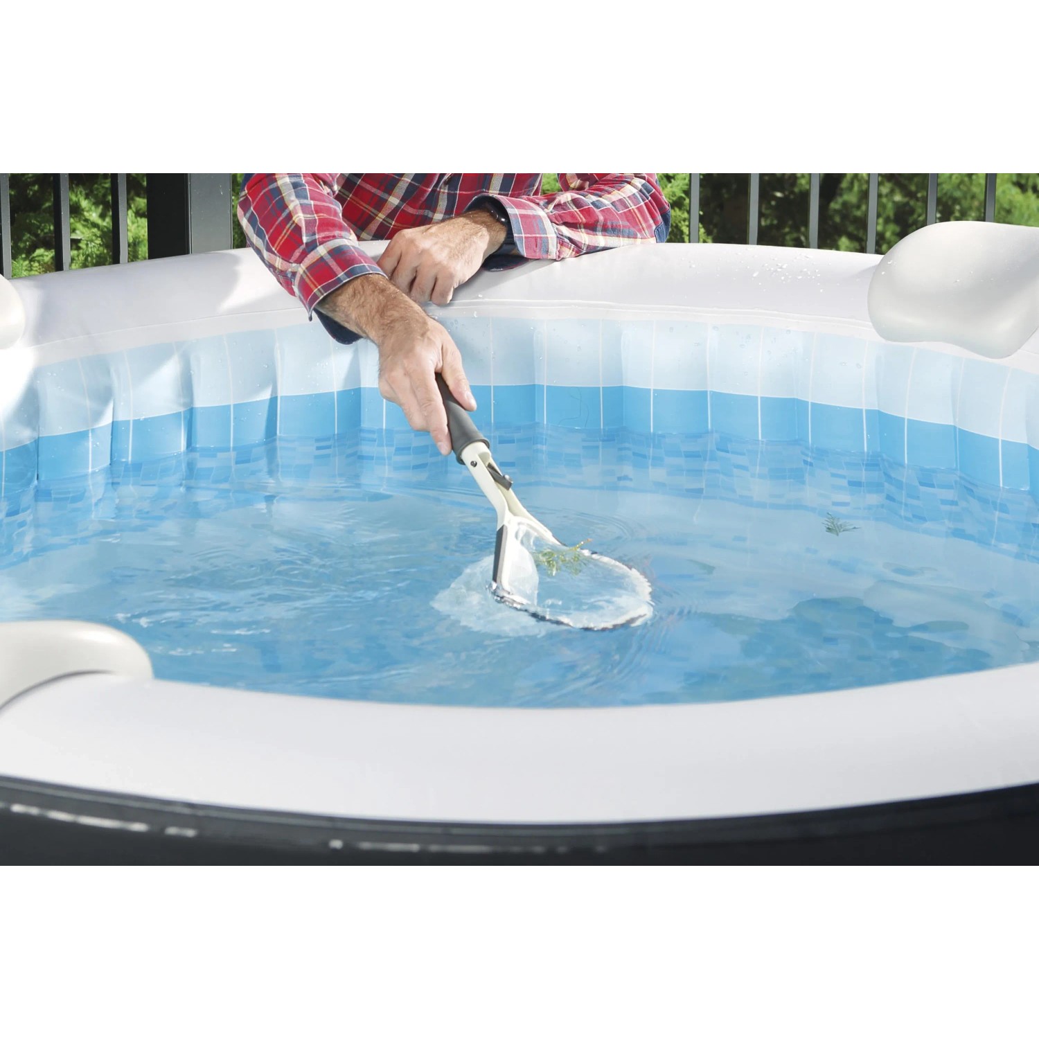 Persona pulisce piscina con retino. Accessori per piscina.