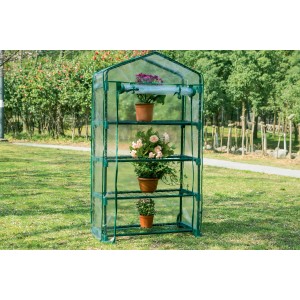 Piccola serra t.b.t. verde con tre ripiani e piante.