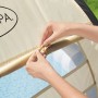 Tettuccio parasole Bestway LAY-Z-SPA, beige, con finestra a rete e mani che lo fissano.