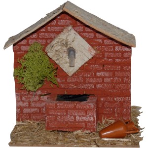 Dettaglio di una scena del presepe con casa in mattoni, muschio e anfora. Categoria: Presepe.