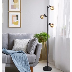 Lampada da terra nera t.b.t. con tre luci in soggiorno.