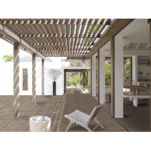 Terrazza con piastrelle in pietra naturale t.b.t. e pergola per un ambiente esterno elegante.