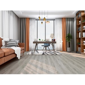 Pavimento vinilico chiaro t.b.t. in soggiorno con divano e scrivania.