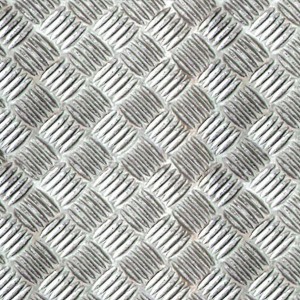 Pellicola adesiva t.b.t. argentata e strutturata con effetto lamiera mandorlata.