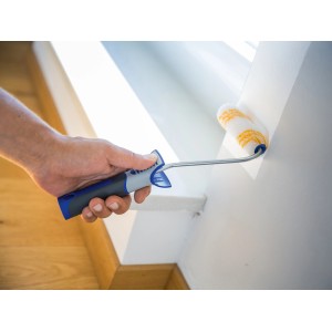 Mano che dipinge la parete con rullo a dispersione LUX (10 cm, poliammide). Rullo per superfici lisce, set da 2 pezzi.