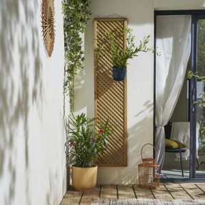 Pannello di recinzione da giardino in legno con piante e decorazioni.