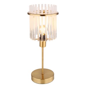 Elegante lampada da tavolo di design con base dorata e paralume trasparente.