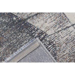 Tappeto moderno con motivo astratto nei toni del grigio e del blu.