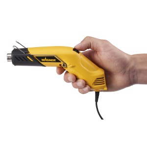 Pistola termica gialla Wagner tenuta in mano, primo piano.