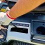 Dettaglio: Mano che aziona la leva sul trattorino tagliaerba. Focus su comandi e comfort.