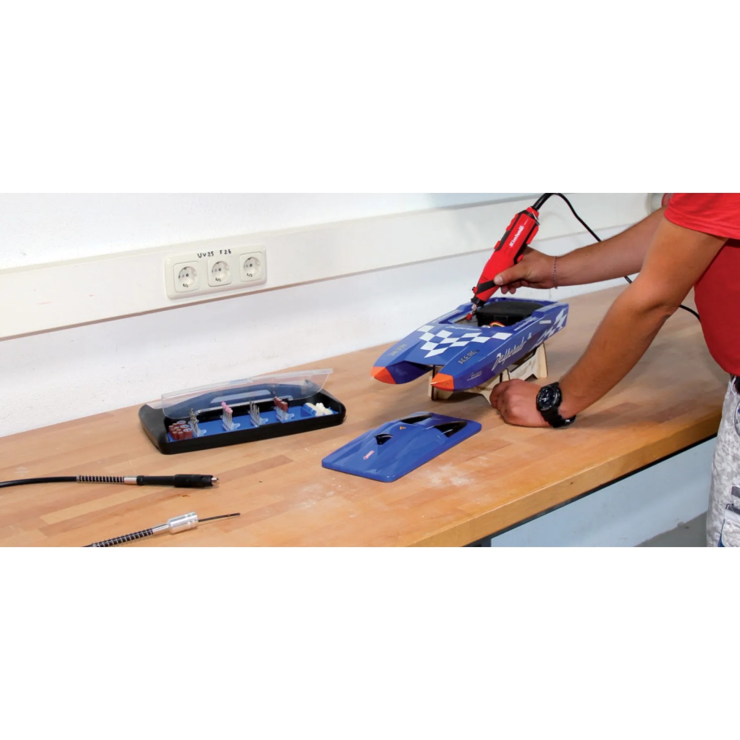 Einhell TC-MG 135 E utensile per levigatura e incisione in uso con accessori e valigetta.