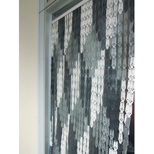 Tenda decorativa per porta t.b.t. nei toni del grigio e del bianco.