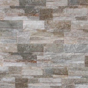 Rivestimento murale t.b.t. con pietre grigie e marroni di diverse dimensioni.