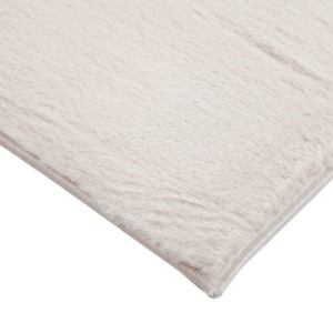 Dettaglio di un tappeto a pelo lungo beige.