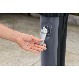 Dettaglio di una doccia da giardino t.b.t. con una mano sulla leva per regolare la temperatura.