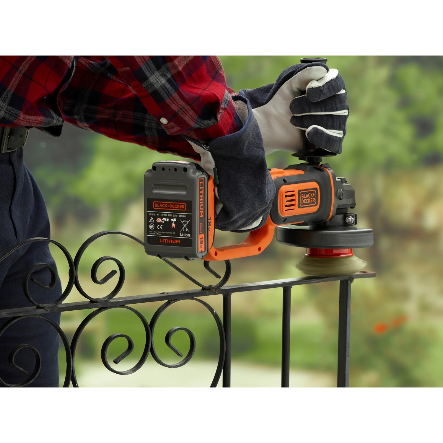 Black+Decker BCG720N smerigliatrice angolare a batteria (18 V, 125 mm) in uso, smerigliatura ringhiera metallica.