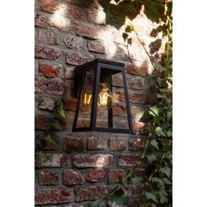 Lampada da parete solare a LED Lutec Fia color antracite su muro di mattoni con edera.